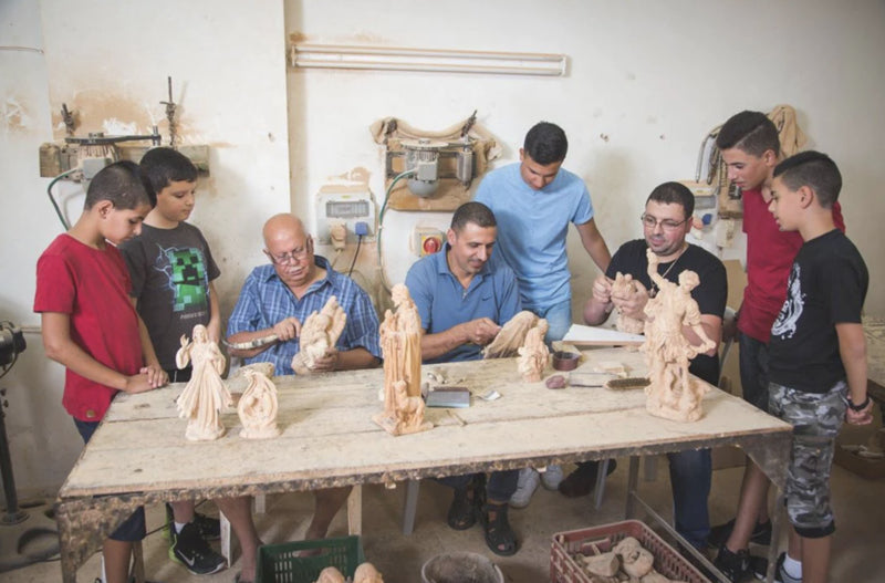 Bannoura family carving olive wood statues
