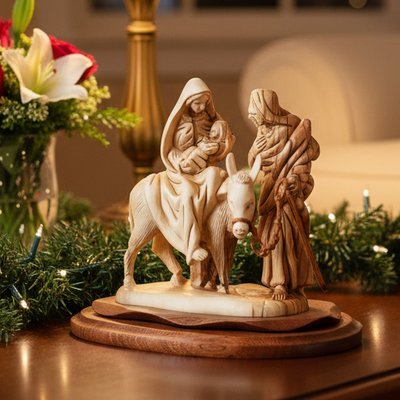 Wooden nativity scene figurine with Mary, Joseph, and donkey on a wooden base.