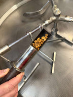Pulling a sample from the roaster to check color and aroma