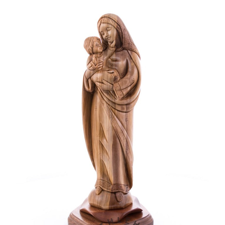 A wooden statue of the Virgin Mary holding a child, crafted from olive wood with a natural finish.