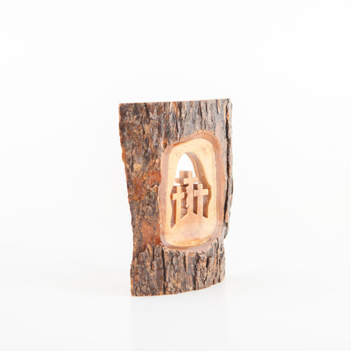 Olive wood Christmas ornament hand carved in Bethlehem, side angle of the olive wood sculpture