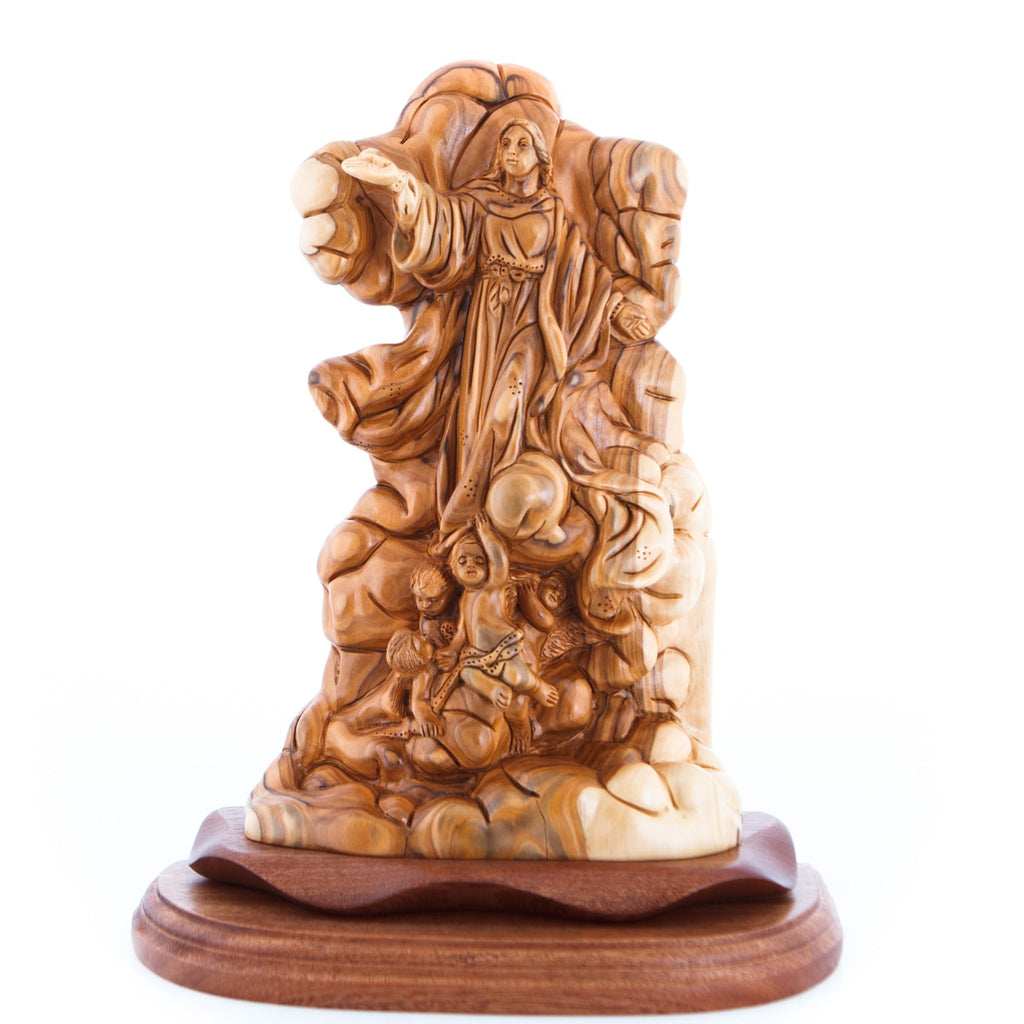A wooden carving of the Assumption of Mary, depicted with a crown of stars and surrounded by intricate woodwork representing the heavens and earth.