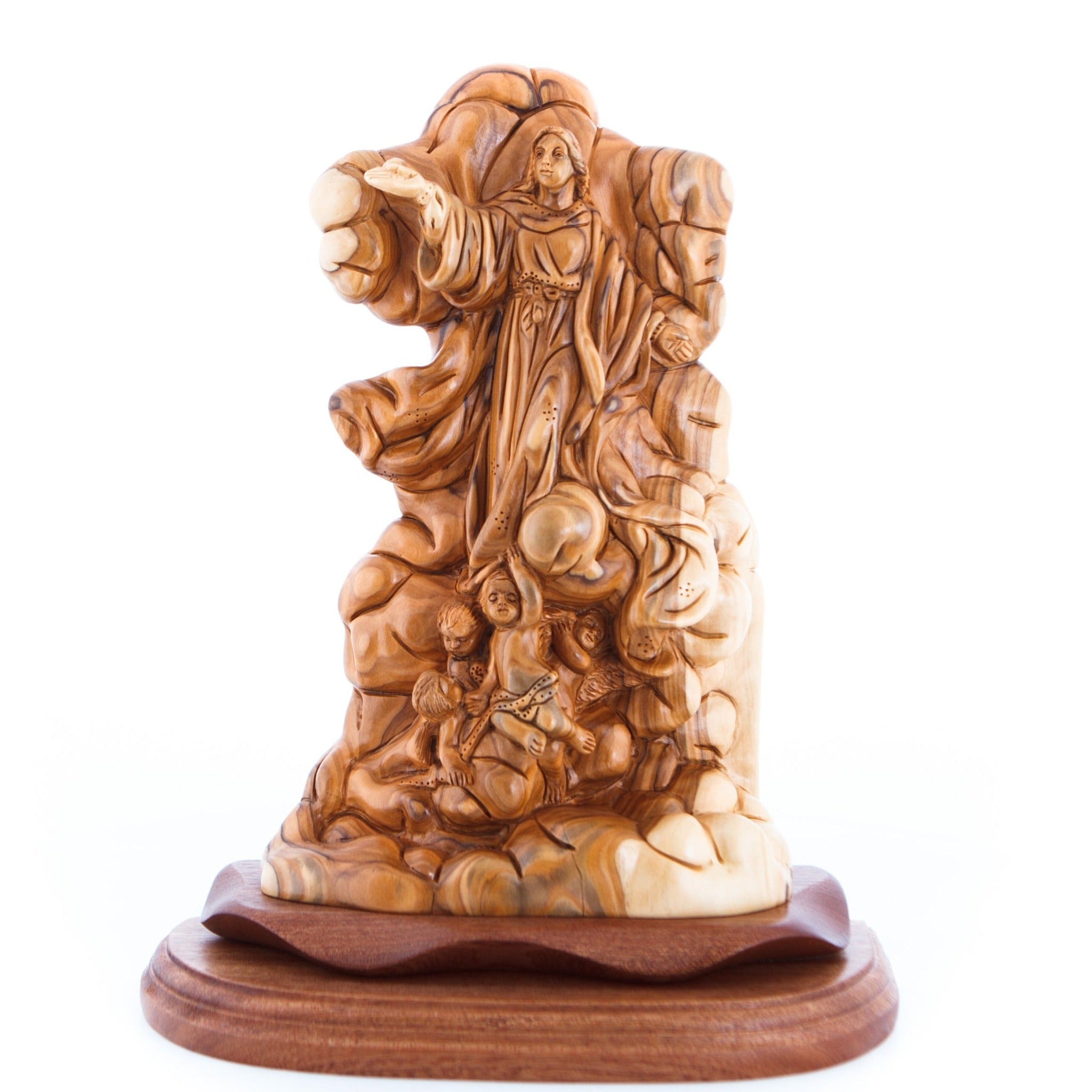 A wooden carving of the Assumption of Mary, depicted with a crown of stars and surrounded by intricate woodwork representing the heavens and earth.
