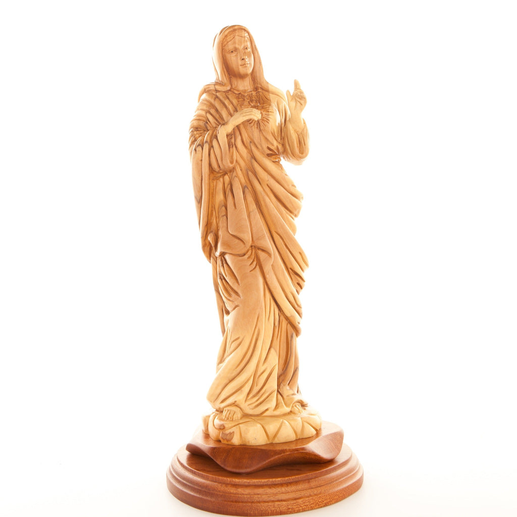 A carved olive wood statue of the Immaculate Heart of Mary, standing on a wooden base.