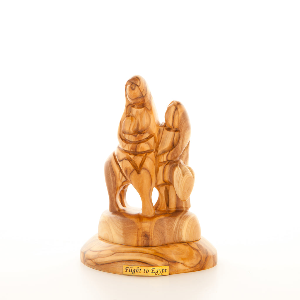 An olive wood figurine depicting the Flight into Egypt, with the figures of Our Blessed Mother and Saint Joseph on a donkey.