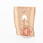 Olive wood Christmas ornament hand carved in Bethlehem, natural light photo of the piece
