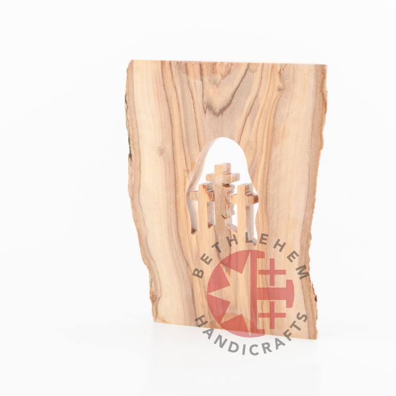 Olive wood Christmas ornament hand carved in Bethlehem, natural light photo of the piece