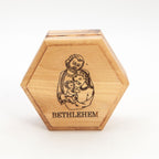 A wooden rosary holder with an engraved image of the Holy Family and the word 'Bethlehem' on the lid.