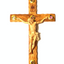A 19 inch olive wood hand-carved crucifix with five glass capsules attached to it, featuring various souvenirs from the Holy Land.