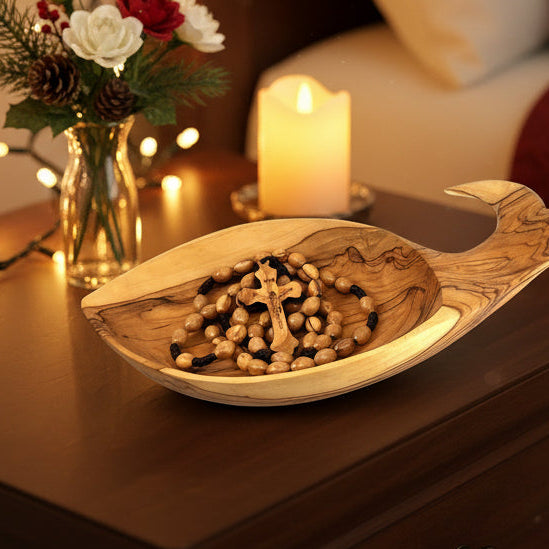 A wooden oval bead rosary with a rope cord, featuring an engraved crucifix.