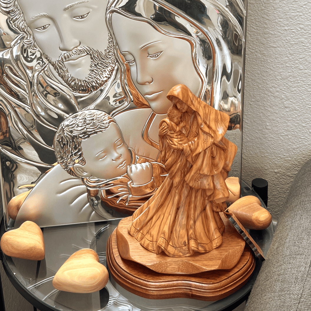 Virgin Mary in Unique Gown, Holding Baby Jesus Christ our Lord, Mahogany Base, Standing in front of Holy Family Silver Icon, with carved hand made gift hearts 