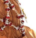 Olive wood rosary hand made in Bethlehem Holy Land, 22.4 inch lifestyle photo on display