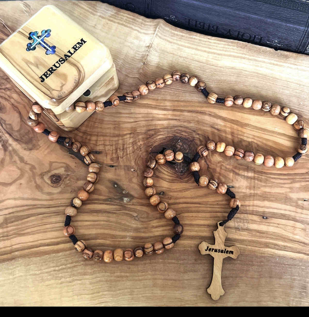 Olive wood rosary hand made in Bethlehem Holy Land, side angle of the olive wood sculpture