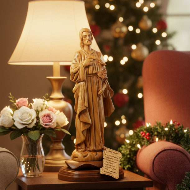 A carved wooden statue of St. Joseph holding a lily flower, next to a ruler for scale.