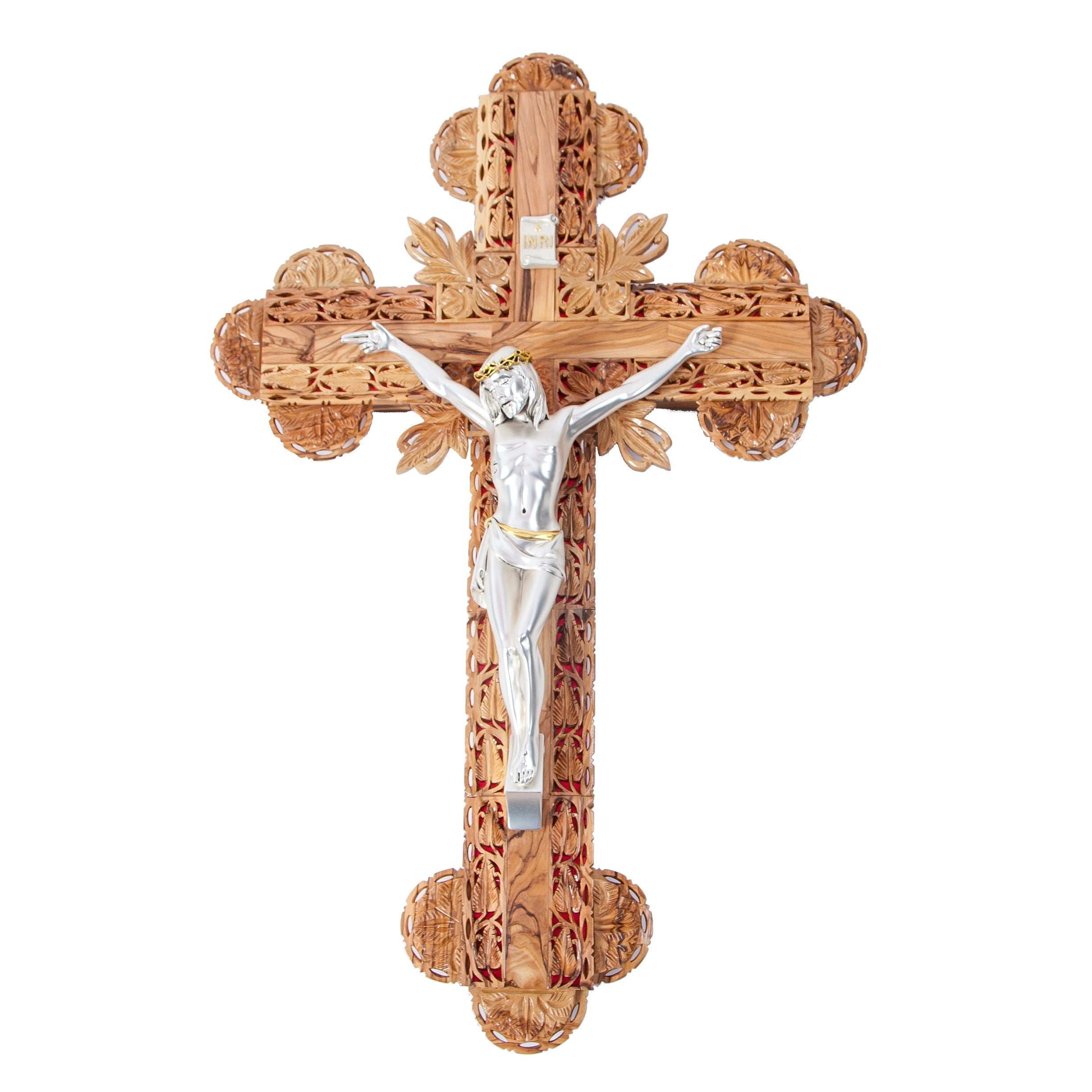 A hand-carved olive wood crucifix with a gold and silver plated corpus, intricately detailed with floral patterns on the cross and a plaque at the top.