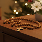 A traditional Catholic rosary with large wooden beads, featuring a cross at the center, hand made from Holy Land olive wood.