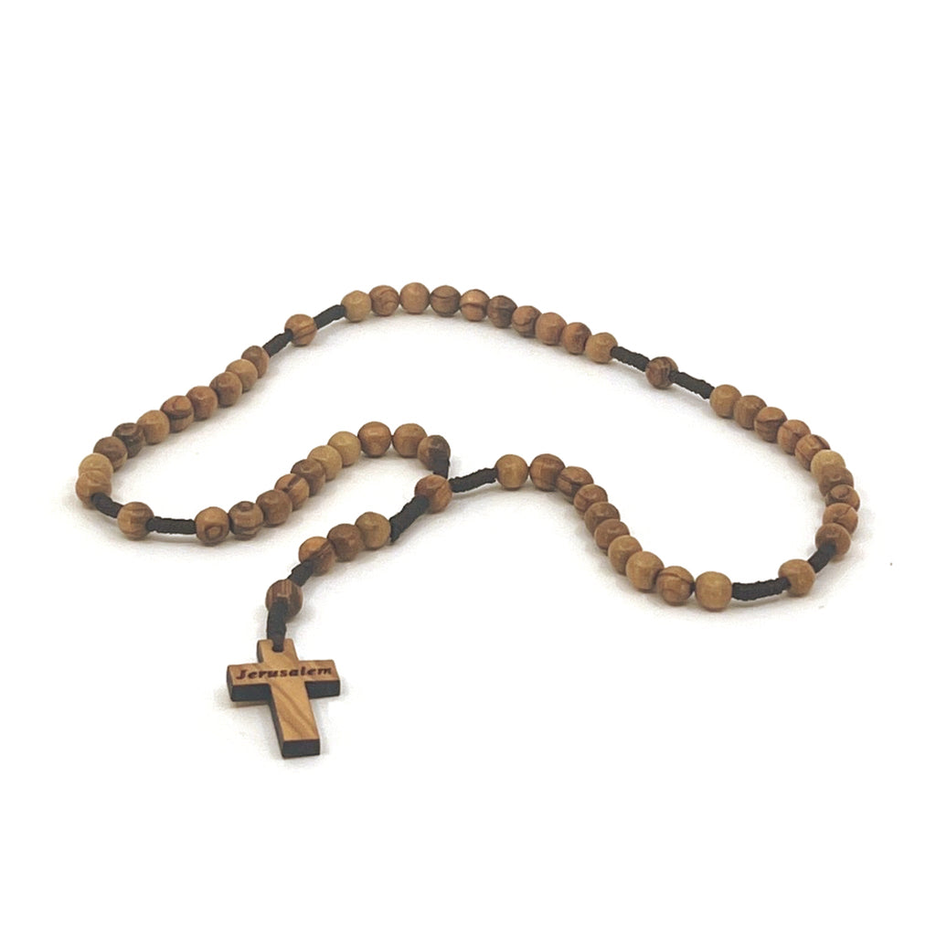 Olive wood crucifix hand carved in Bethlehem, three quarter view of the religious piece